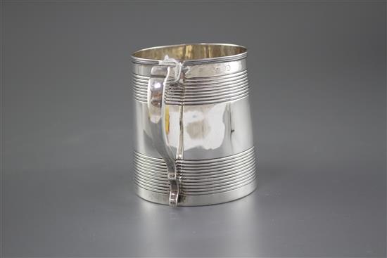 A Georgian reeded silver mug, (marks rubbed and top of handle is repaired), height 96mm, 8.5oz.
